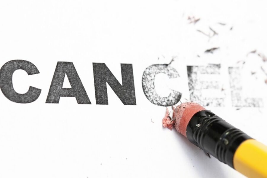 A photograph of the word 'cancel' being erased