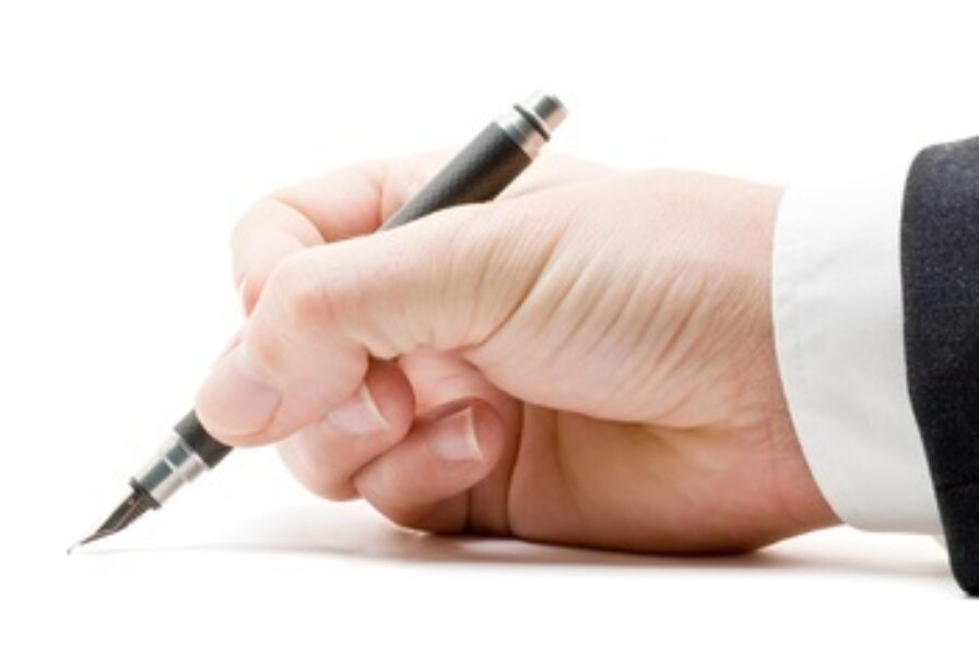 Photograph of person signing standard letter
